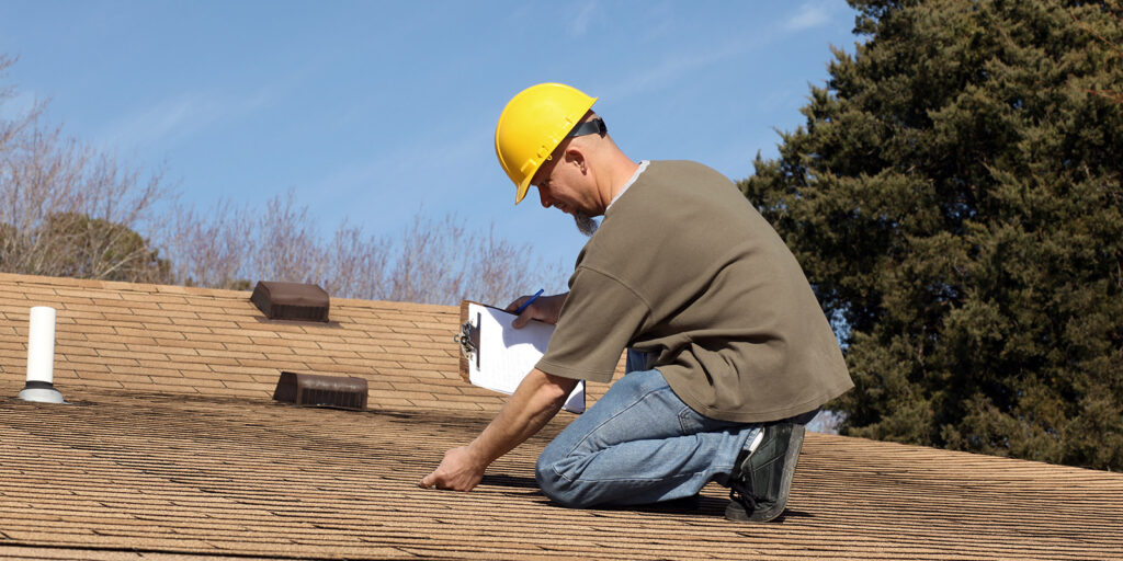 Roofer inspecting roof