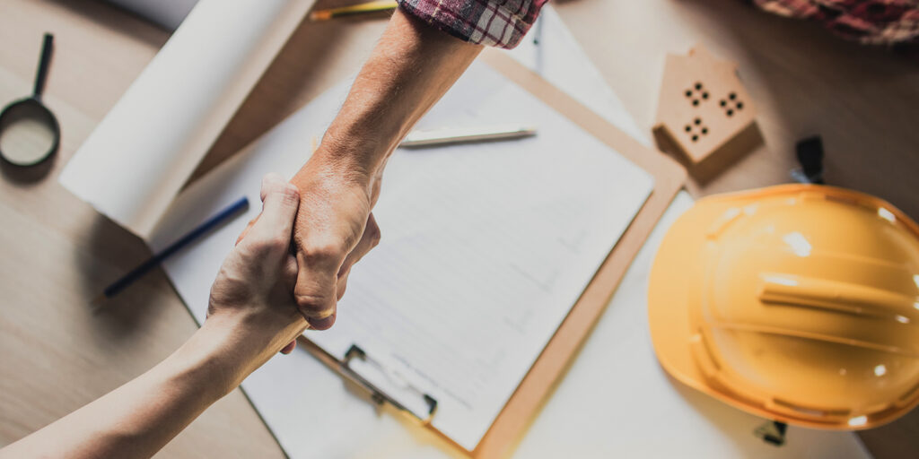 roofing contractor shaking hands with homeowner